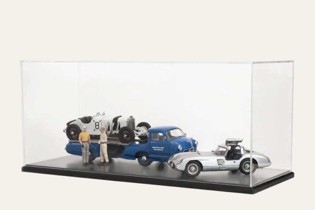 Black tabletop display case with a Mercedes-Benz race car transporter diorama