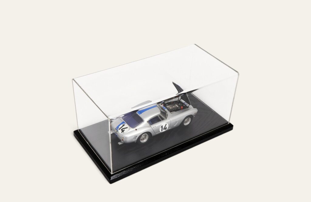Silver No. 14 race car model in a black tabletop display case