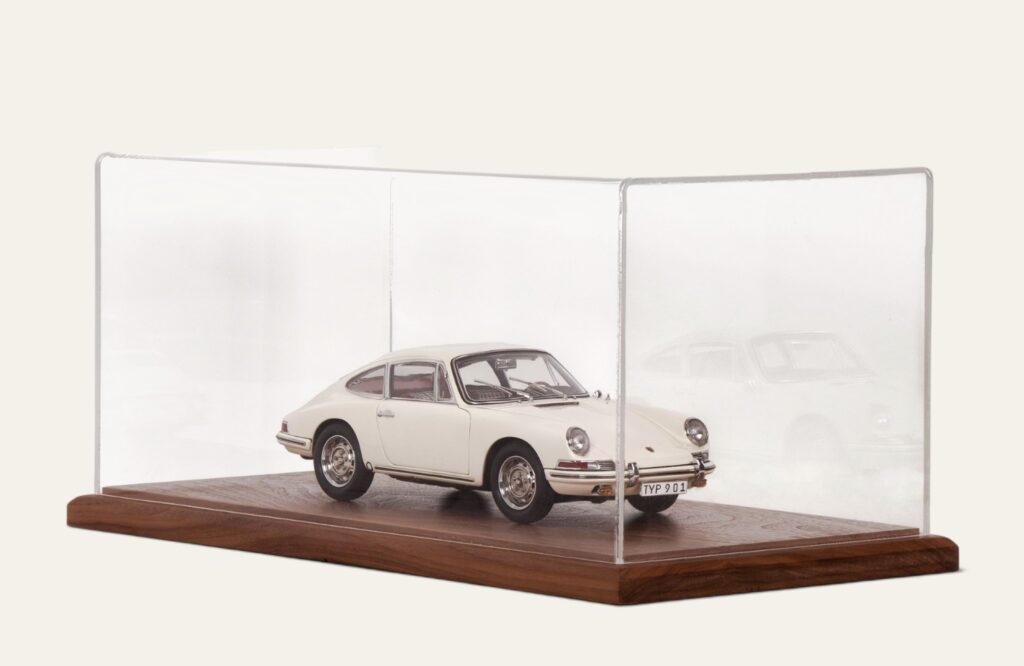 Walnut tabletop display case with a white vintage Porsche model car