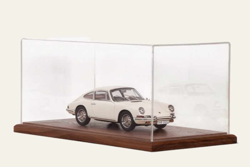 Walnut tabletop display case with a white vintage Porsche model car