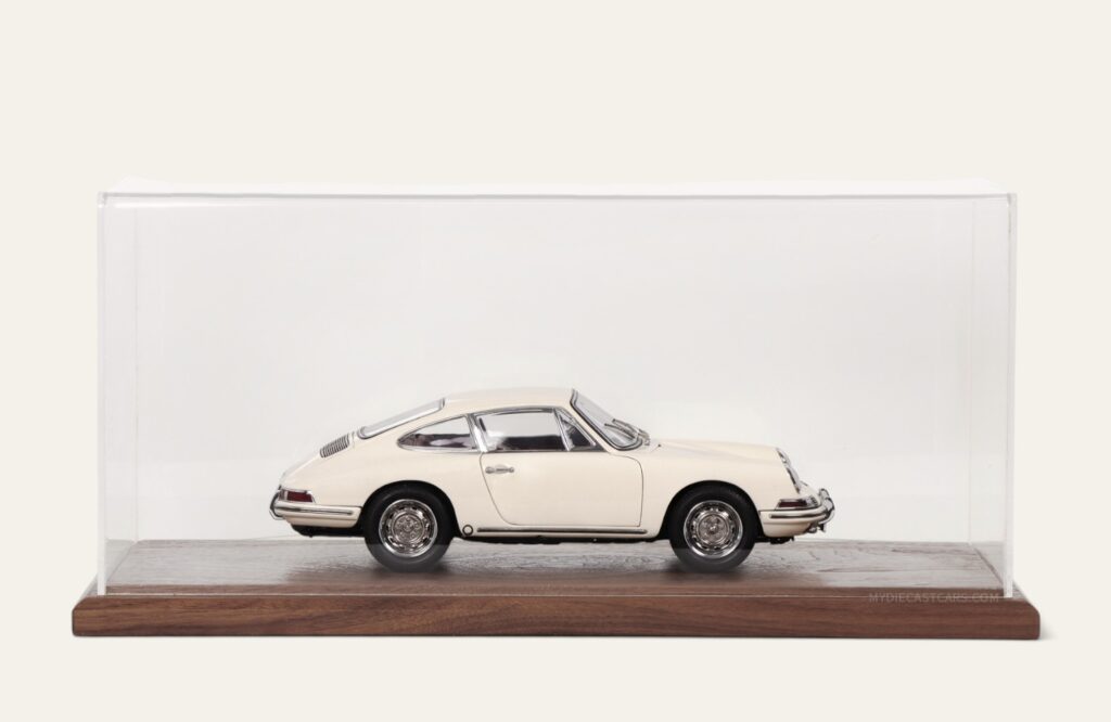 Cream Porsche model car in a walnut tabletop display case, side view