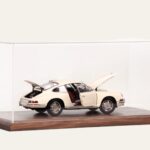 Walnut display case with a cream Porsche model car, doors and engine cover open