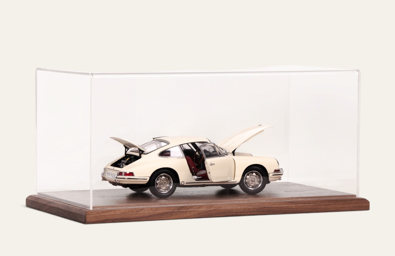 Walnut display case with a cream Porsche model car, doors and engine cover open