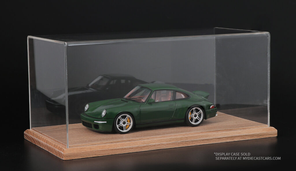 Green sports car model in a clear acrylic display case
