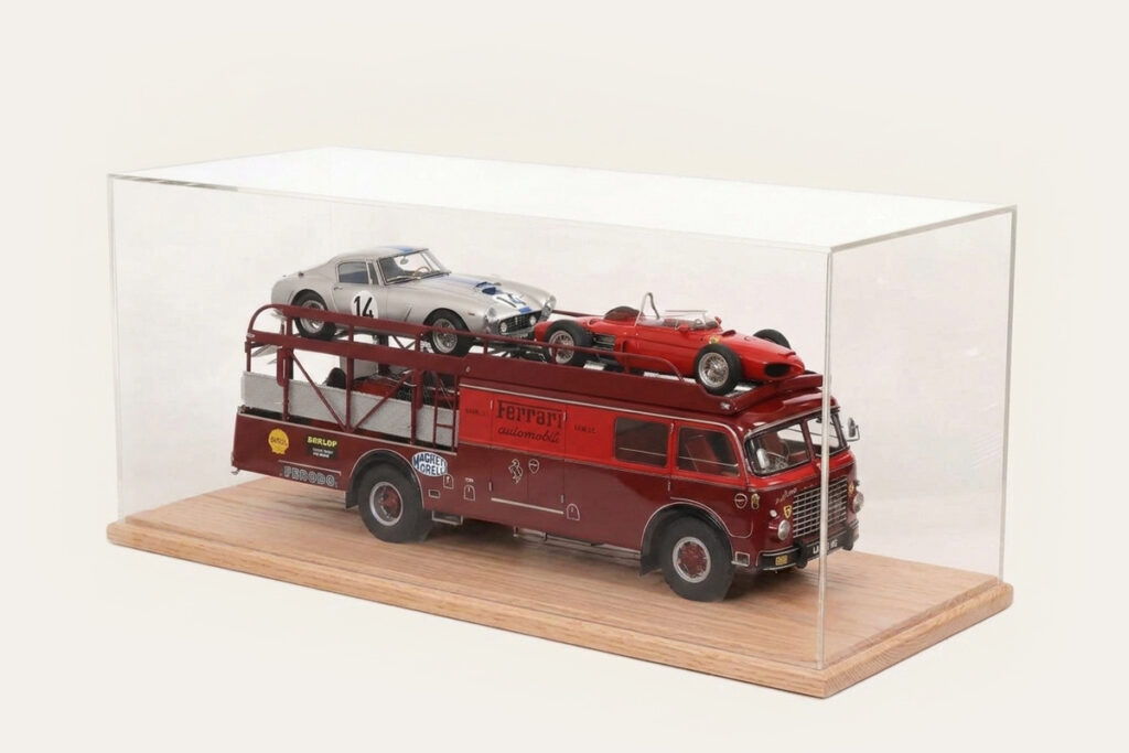 Oak tabletop display case with a Ferrari-liveried car transporter and two model cars