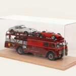 Oak tabletop display case with a Ferrari-liveried car transporter and two model cars