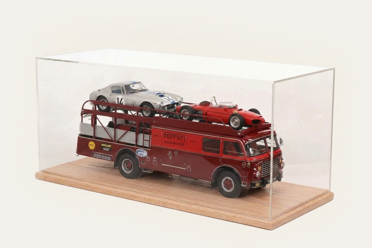 Oak tabletop display case with a Ferrari-liveried car transporter and two model cars